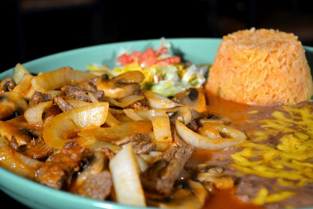 Steak Picado · Top sirloin sliced and sauteed with onions, mushrooms and onions covered with Spanish sauce. Served with rice and beans.