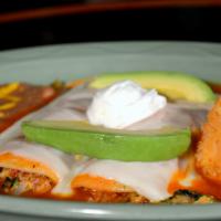 Crab Enchiladas · 2 tortillas filled with real crab meat, onions, tomatoes and topped with cheese and enchilad...