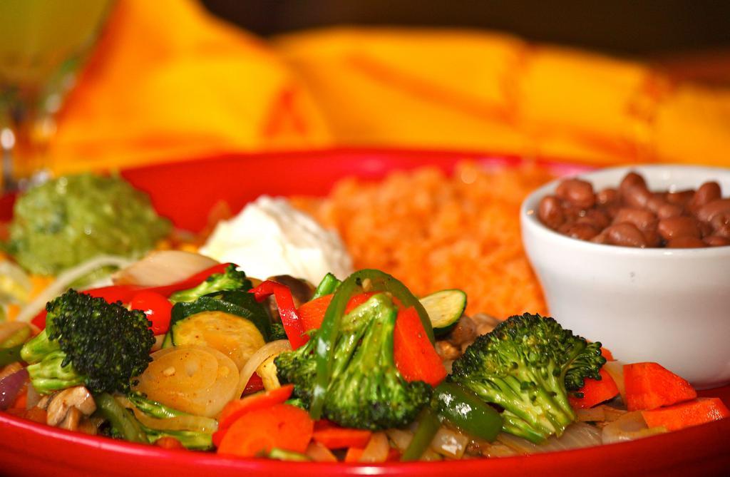 Veggie Fajitas · Sauteed mushrooms, carrots, zucchini, broccoli, onions, green and red bell peppers. Served with rice, beans, guacamole, sour cream and choice of corn or flour tortillas.