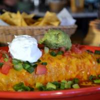 Deluxe Burrito Manadero Enchilada · Ground beef with beans and rice wrapped inside a flour tortilla, then topped with enchilada ...