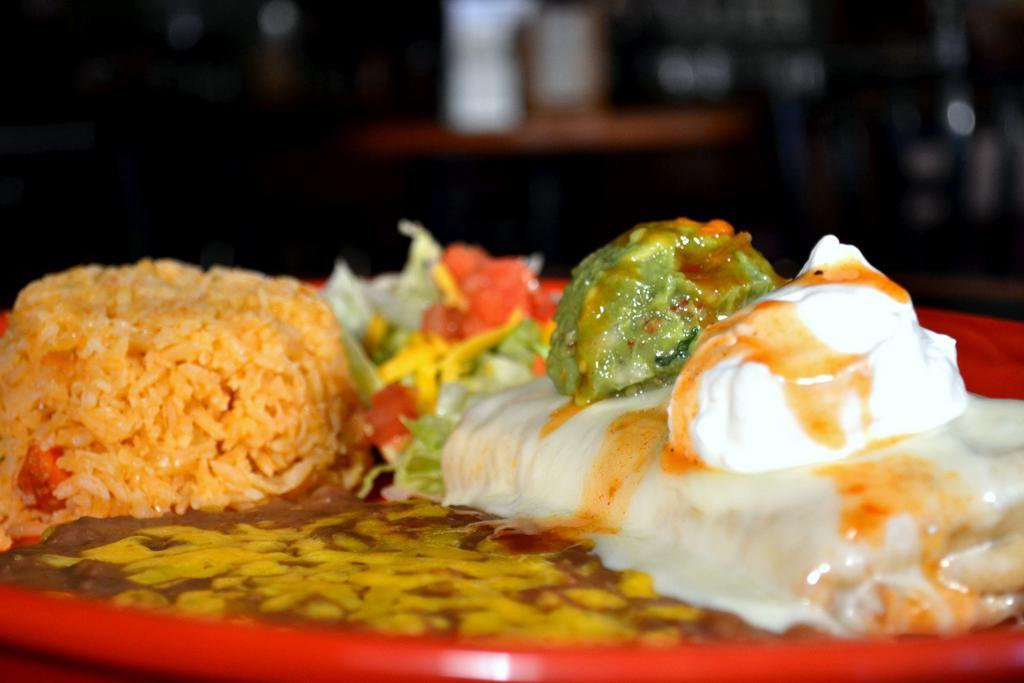 Chimichanga · Flour tortilla filled with protein. Deep fried and served with cheese, sauce, guacamole, sour cream, rice and beans. Not served with rice and beans.