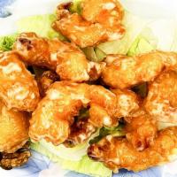Honey Glazed Walnut Shrimp · Crispy fried shrimp coated in a creamy sweet sauce on top of a bed of lettuce with candied w...