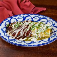 Azteca Burrito · Delicately slow cooked beef brisket and rice. Covered with a half each of our homemade green...
