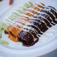 Trio Mole Enchiladas · Oaxaca & pulled chicken with black mole, Queso fresco & Oaxaca cheese with red mole and carn...