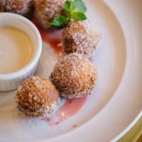 Donitas · House-made sweet dough vanilla fritters dusted in sugar, served with vanilla cream and abuel...