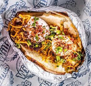 Loaded Baked Potato · Large baked potato with sour cream, butter, cheddar cheese, bacon bits, and chives
