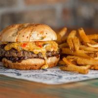 Cheddar Pepper Burger · Half pound burger with caramelized onions and roasted pepper cheese mix on a jalapeno chedda...