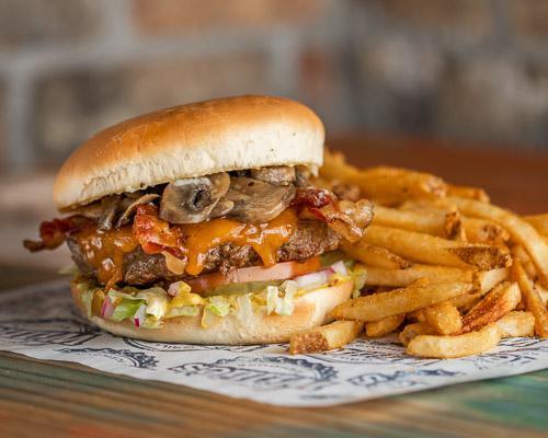 Icehouse Burger · Half pound certified Angus beef patty, cooked medium well topped with cheese, bacon, mushrooms, mayo, mustard, lettuce, tomatoes, pickles, onions, and served with choice of side.