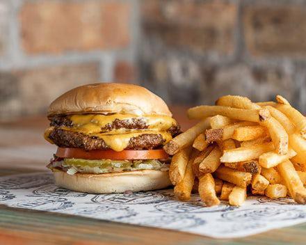 Founders' Favorite Burger · Double junior patties, double cheese, tomatoes, onions, pickles, and lettuce served with choice of side.