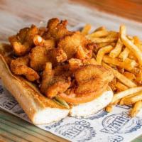 Shrimp Po-Boy · Grilled, fried or blackened shrimp served on hoagie roll with lettuce and tomato, and served...