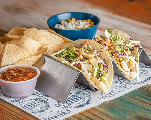 Mahi Mahi Tacos · Grilled or blackened Mahi Mahi with cabbage slaw and chipotle mayo served on corn tortillas served with choice of two sides.