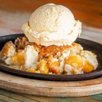 Peach Cobbler · Made from scratch peach cobbler topped with vanilla ice cream