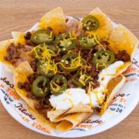 Mexican Nachos · Cheese, ground beef, sour cream, beans and jalapenos.