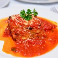 Parmigiana di Melanzane · Baked eggplant layered with mozzarella and Parmesan cheese served in a delicate fresh tomato...