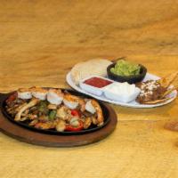Fajitas Mixtas · Grilled chicken, beef and shrimp served with beans guacamole and tortillas.