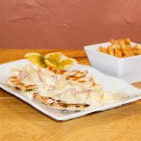 Pechuga en Crema de Pina · Grilled chicken breast topped with pineapple sauce and ham served with salad, rice and beans...