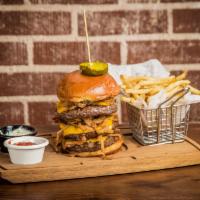 The Boss Burger · Three eight-ounce patties (24 oz), Applewood smoked bacon, onion rings, American cheese, and...