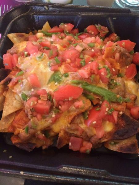 Nachos · Crispy corn chips, topped with refried beans, melted cheddar cheese, california red chile sauce, pico de gallo, sour cream and guacamole.