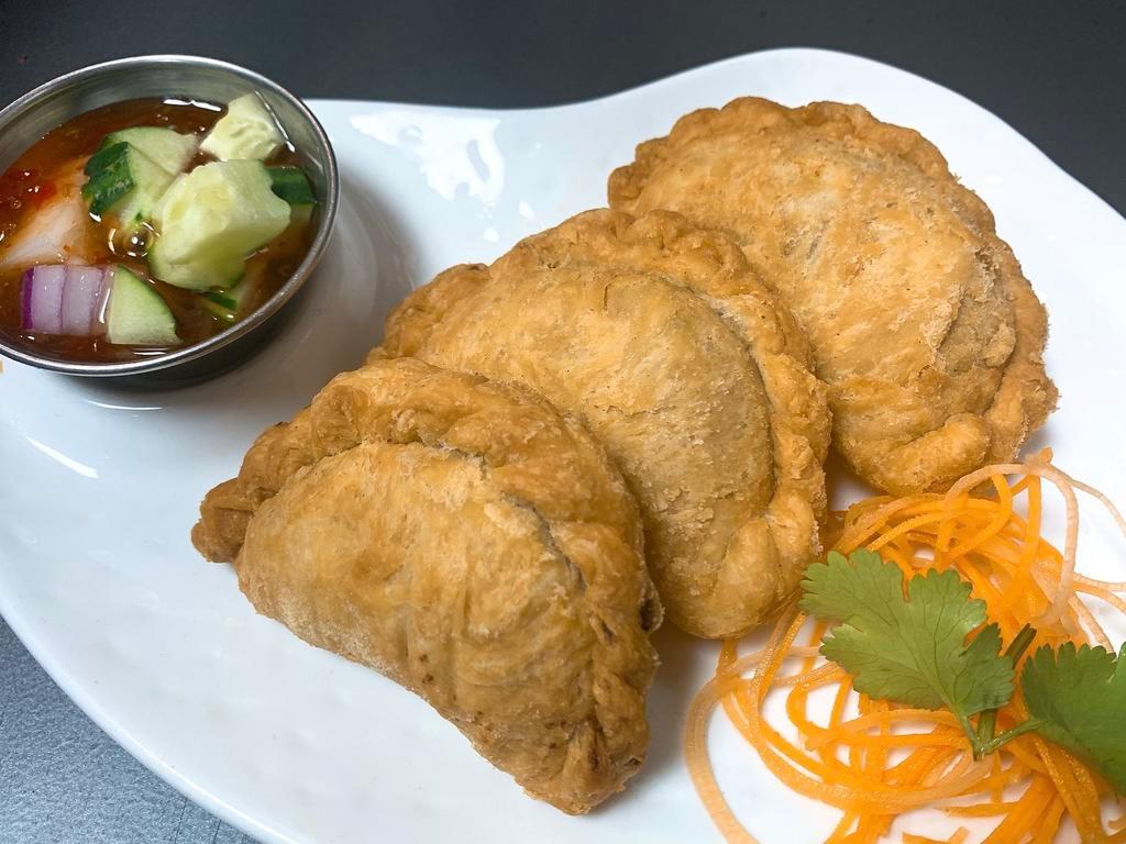 Curry Puff · 3 pieces. Puff pastry stuffed with chopped chicken, potatoes, onions, curry powder and served with cucumber sauce.
