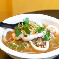 Seafood Tom Yum Noodle Soup Bowl · Shrimp and squid with thin rice noodles in tom yum broth, bean sprouts and ground peanuts. S...