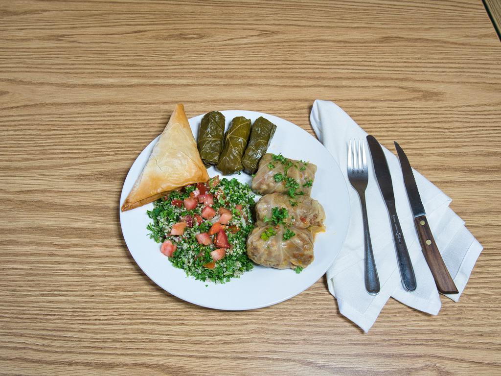 Dolma Cabbage Plate · Ground beef meat mixed with rice, parsley, onions, special spices, tomatoes, bell peppers and wrapped in boiled cabbage leaves.