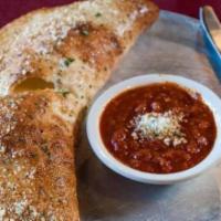 Cheese Calzone · Stuffed with ricotta and mozzarella cheese.  Baked ’til golden brown and served with side of...