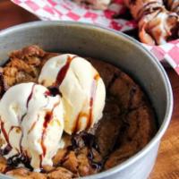 Chocolate Chunk Piz-ookie · Half a pound of cookie dough baked in a 6 inch pizza pan and topped with vanilla ice cream.