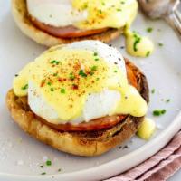 Classic Eggs Benedict · 2 poached eggs with Canadian bacon on English muffin topped with our house hollandaise sauce.
