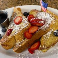 Fresh Berries French Toast · 3 slices of thick-cut of Raisin Challah bread dipped in egg batter with a special touch of c...
