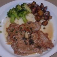 Vitello Piccata · Veal sauteed with capers and chopped onions in a white wine and lemon sauce. Served with pot...
