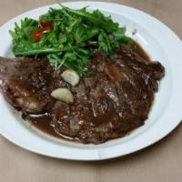 Tagliata di Manzo · Rib eye steak sliced and topped with arugula and cherry tomatoes in a light red wine sauce. ...