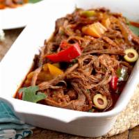 Ropa Vieja  · Shredded flank steak with roasted peppers and onions served with your choice of two sides 
