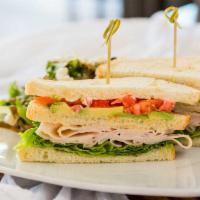 Club Sandwich · 3 slices of sourdough bread piled with turkey, bacon, green leaf lettuce, fresh tomato, avoc...