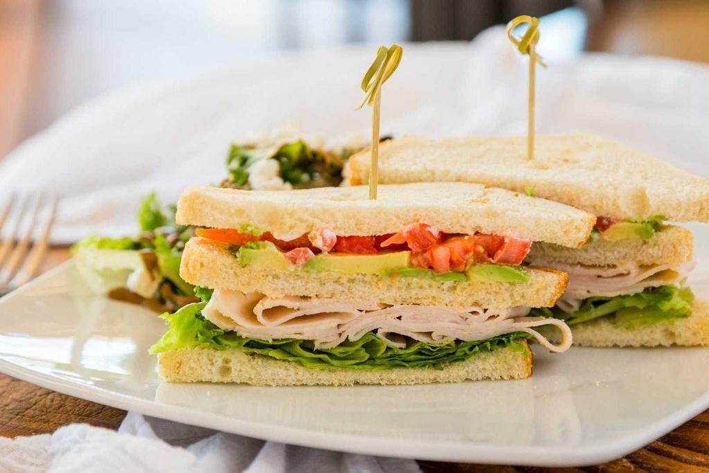 Club Sandwich · 3 slices of sourdough bread piled with turkey, bacon, green leaf lettuce, fresh tomato, avocado, and mayo.
