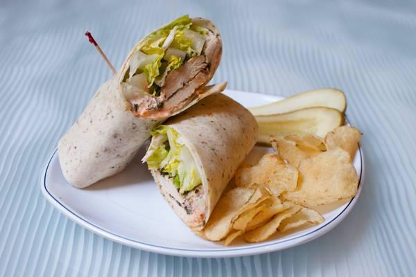 Buffalo Chicken Wrap · Oven-roasted chicken breast and romaine lettuce with house-made blue cheese dressing and sriracha sauce. Add cheese for an additional charge.