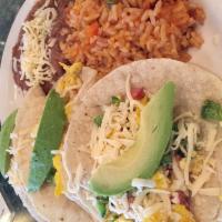 Breakfast Tacos · Scrambled eggs, smoked sausage, green pepper, onion and chihuahua cheese with rice and beans...