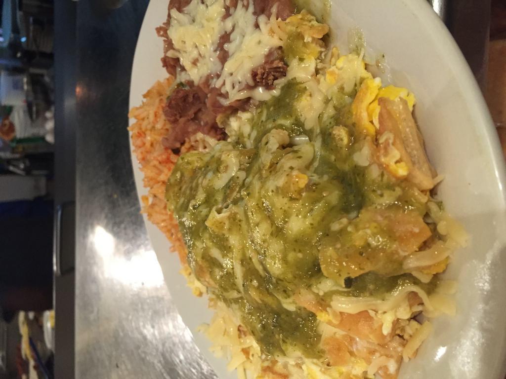 Chilaquiles · 3 eggs scrambled with house-made tomatillo sauce, chihuahua cheese and tortilla chips with rice and beans. Tortillias in chilaquiles. Additional tortillas extra charge.