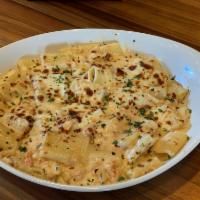 Seafood Pasta al Forno (NEW) · Mezzi Rigatoni pasta baked with lobster and shrimp, in a creamy Alfredo, with crushed red pe...
