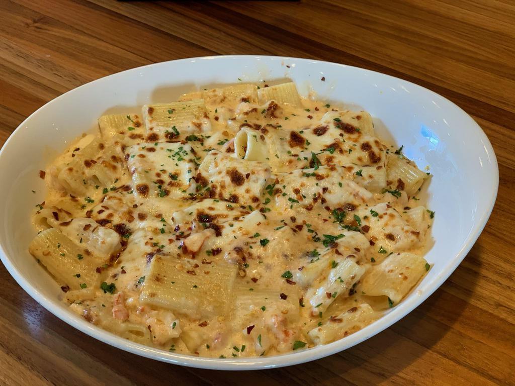 Seafood Pasta al Forno (NEW) · Mezzi Rigatoni pasta baked with lobster and shrimp, in a creamy Alfredo, with crushed red pepper and mozzarella, served with a side salad