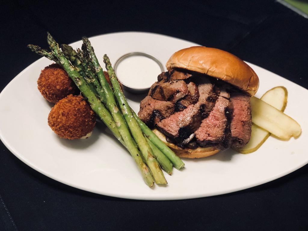 Prime Beef Filet Sandwich Lunch · Iowa beef filet cooked to order, served with cremini mushrooms, sauted onions, aged white cheddar, with a horseradish cream on a brioche bun. Includes choice of side.