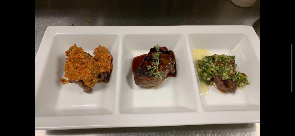 Prime Steak Trio · A trio of steaks: beef, bison and Wagyu Beef, each with a unique preparation (bison with pecan pimento chimichurri, beef with torrey pines, and Wagyu Beef)
