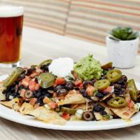 Nachos · House-made chips, cheddar, and Jack cheeses, pico de gallo, guacamole, sour cream, olives, j...