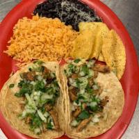 Dos Tacos Plate Tacos · Served on either flour or corn tortillas, choice of meat, served on a plate with black or pi...