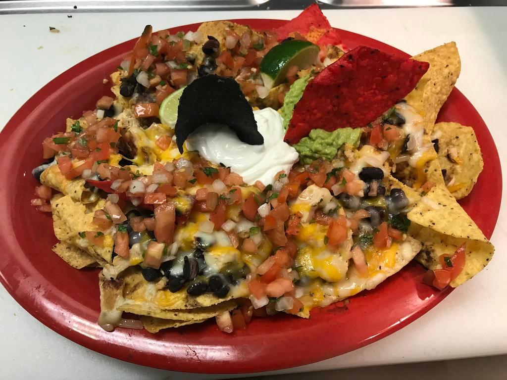 Nachos · Choice of meat, melted jack and cheddar cheese, black and pinto beans, pico de gallo, guacamole and sour cream.