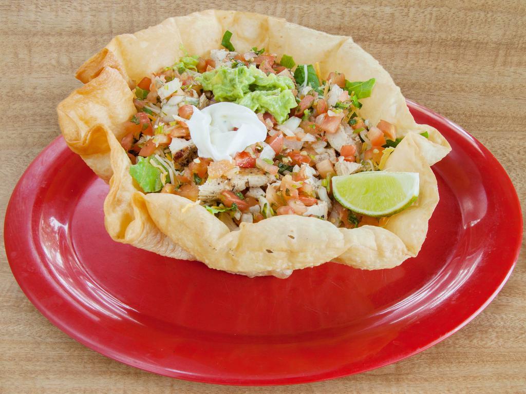 Taco Ensalada · Tortilla bowl served with your choice of meat, black or pinto beans, mixed greens, pico de gallo, jack and cheddar cheese and sour cream.