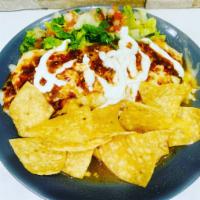 Wet Burrito · Choice of meat, rice, bean, covered with a sauce, melted cheese, along with lettuce, pico de...