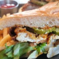 NASHVILLE HOT CHICKEN SANDWICH · Fried chicken breast, lettuce, pickles, Nashville hot aioli, ciabatta