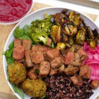 Tri Tip Steak Warm Rice Bowl · Purple rice, grass-fed steak, roasted vegetables, falafel, arugula, pickled jalapenos, pickl...