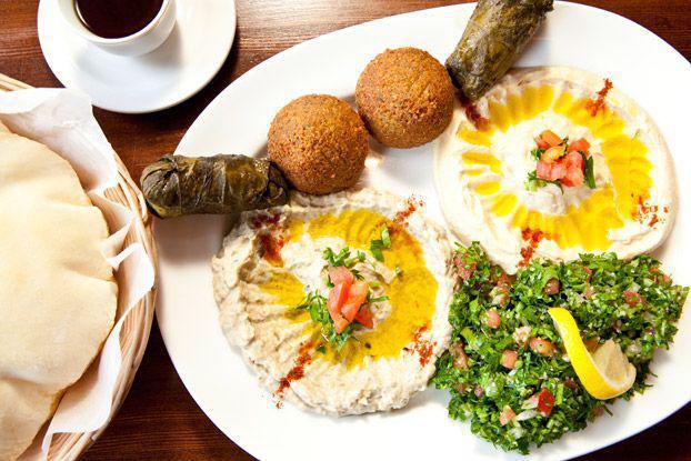 Meza Plate · An assortment of hummus, falafel, baba ghanouj and stuffed grape leaves served with tahini sauce and pita bread.