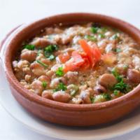 Foul Moudamas · Egyptian fava bean dip with lemon juice, olive oil, tahini, and special spices served with p...